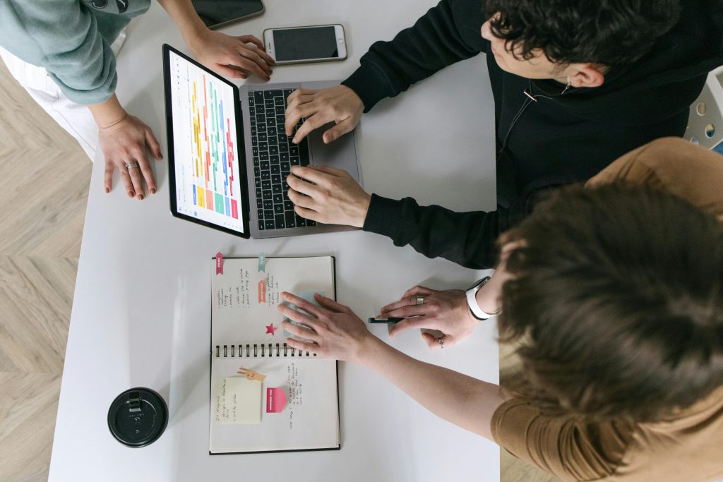 pexels-photo-7213547-7213547 A high-angle view of a team collaborating over a laptop and notebook in a modern office.