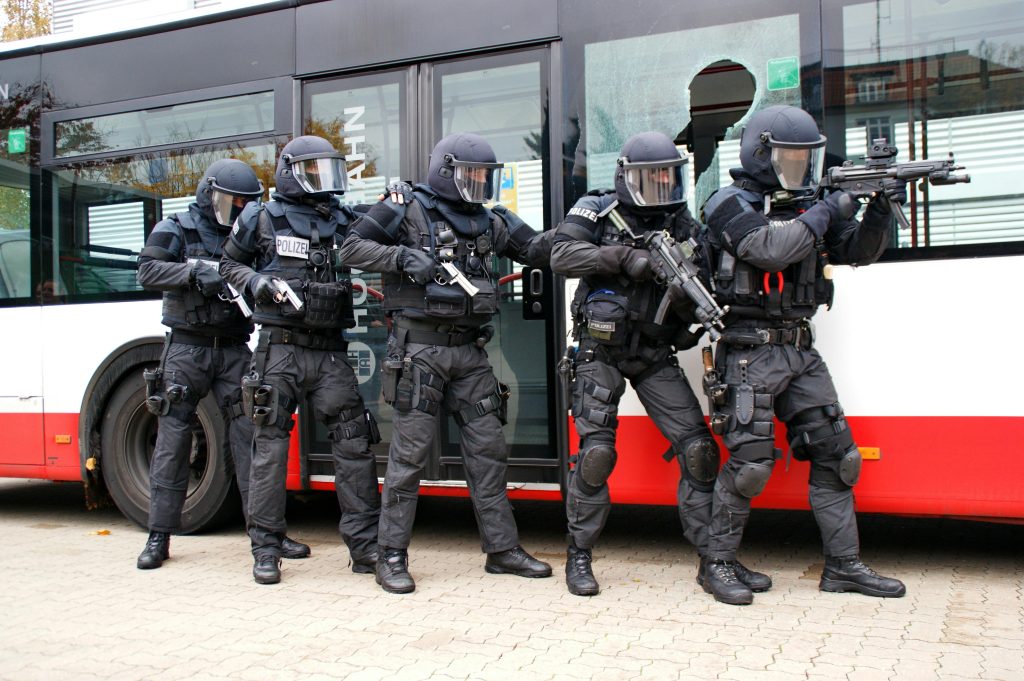 pexels-photo-15679743-15679743 Armed police officers in tactical gear performing an operation on a bus.