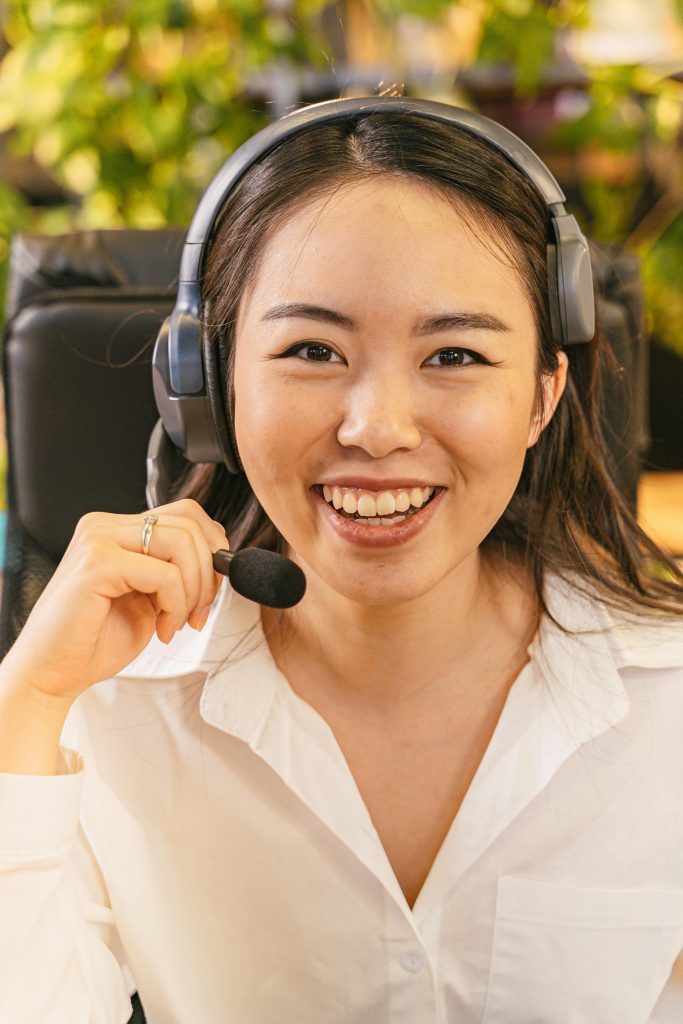 pexels-photo-8192005-8192005 A young woman in an office setting wearing a headset, ready to assist over the phone.